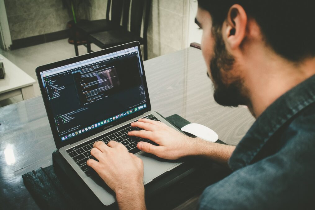 man typing on a computer